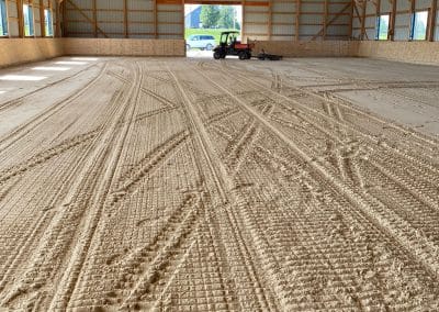 leveling synthetic dustless ThorTurf on an indoor arena